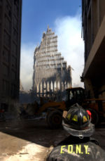 [September 13, 2001: A New York City firefighter looks up at what remains of the South Tower.]